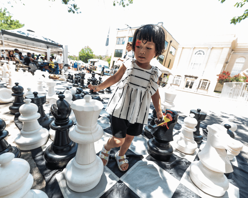 A girl plays at KidsFest at AthFest.