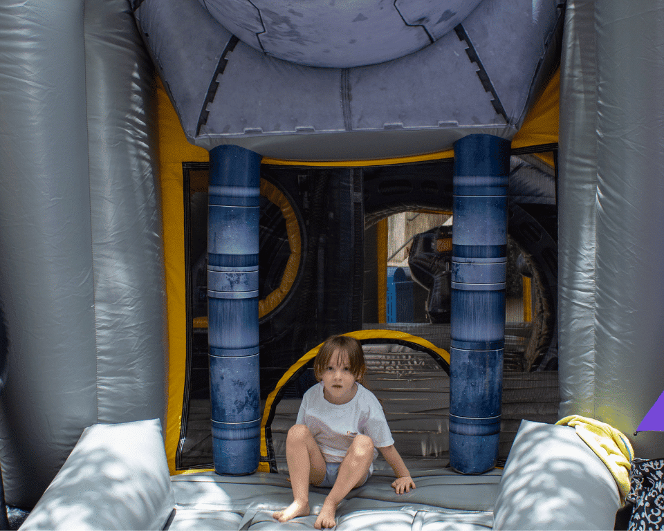 A child on an inflatable bounce house at KidsFest at AthFest 2024.
