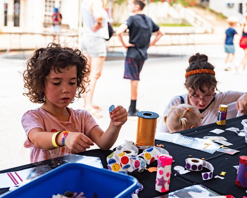 A girl paints at KidsFest at AthFest.